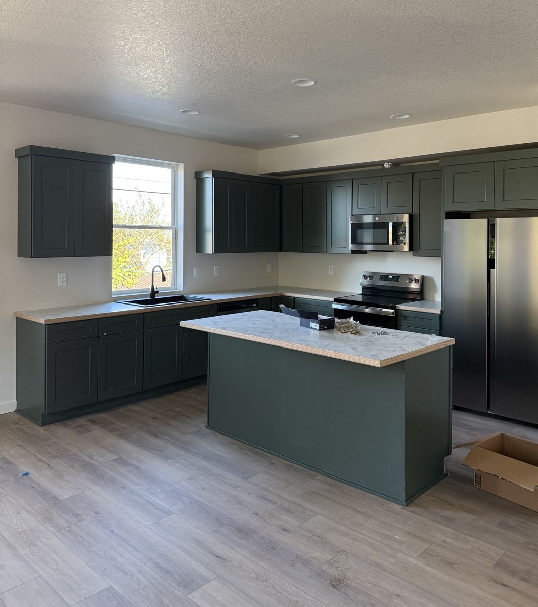 Dark green shaker kitchen with island